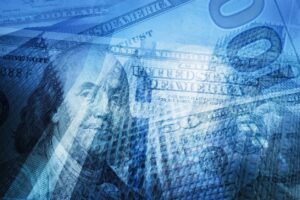 Corpus Christi launches: A digitally stylized collage of U.S. currency, including overlapping images of a $100 bill featuring Benjamin Franklin and a $50 bill, with a blue-toned financial theme.
