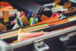 Operation Safe Return Aims to provide colorful folders, pens, and supplies like those shown in this organized school supply kit.