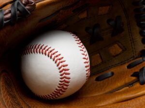 Close-up of a baseball resting in a leather glove, symbolizing MLB action as Astros welcome back Yordan Alvarez to the lineup.