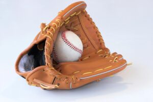 Baseball glove holding a ball on a white background, symbolizing Astros sign Craig Kimbrel to strengthen bullpen depth.