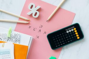 Calculator, notebooks, and pencils on a desk with the word “TAX PLAN,” symbolizing budgeting as Corpus Christi approves higher rates.