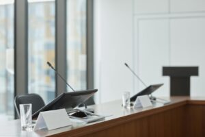 Corpus Christi Assistant City council chamber with empty microphones and nameplates, symbolizing leadership changes and resignation.