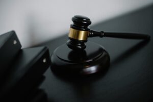 Judge Rules in Favor of Nora Canales with symbolic gavel on desk representing court decision and estate dispute settlement.