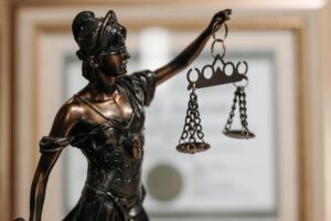Close-up of Lady Justice statue holding scales, symbolizing law and fairness, used in story about Texas School Districts Face lawsuits.