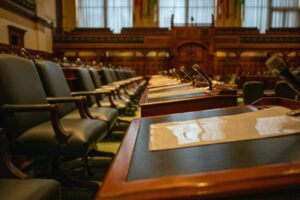 Empty council chamber with rows of seats and microphones prepared for a meeting as Desalination Talks Return to the agenda.