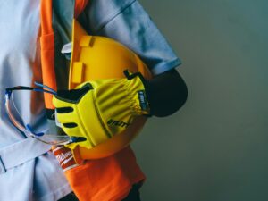 Construction worker holding safety gear and helmet, symbolizing bridge decommissioning and progress — Goodbye to an Icon.