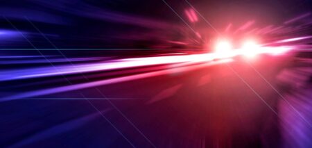 Abstract red and blue light streaks resembling police emergency lights, symbolizing a breaking news or public safety incident.