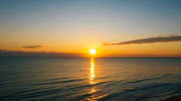 Golden sunrise over calm Gulf waters, reflecting on gentle waves ahead of Bob Hall Pier reopening.