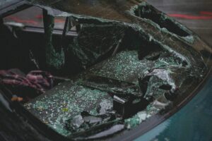 Shattered glass covers the interior of a damaged vehicle following the Flour Bluff ISD school bus crash on SPID.