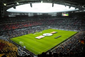 Packed soccer stadium with fans and teams lined up on the pitch during Argentina vs Honduras international match event