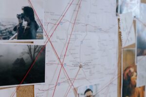 Investigation board with map, photos, and red strings linking clues in a missing case — Angelita Martinez missing