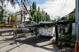 Coastal Bend power outages after severe weather as utility crews clear fallen power lines blocking a roadway.