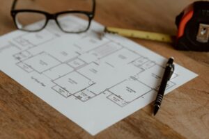 Nueces River Authority investigation: Blueprint plans, glasses, and office tools representing infrastructure planning.