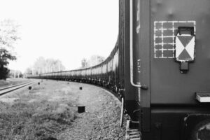 Black-and-white freight train on railroad tracks tied to the South Texas boxcar deaths investigation.