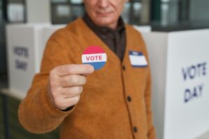 Texas GOP runoff voter holds a vote sticker inside a polling station during election day.