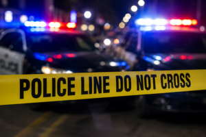 Police tape and flashing patrol lights at night following the Cole Park shooting investigation in Corpus Christi.