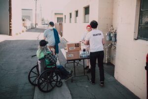 Volunteers distribute aid and supplies to residents during a Coastal Bend disability services outreach event.