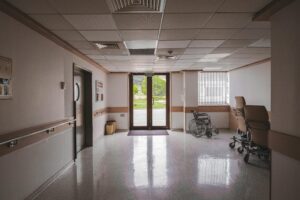Hospital hallway with wheelchair and waiting chairs highlighting expanded Coastal Bend forensic care access for survivors.