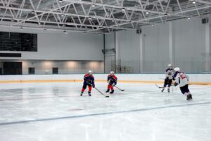 Youth hockey players compete on an indoor ice rink during practice as Houston hockey expansion gains momentum.