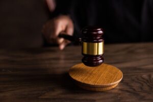 Judge’s gavel striking a sound block during court proceedings, symbolizing legal decisions and judicial process.