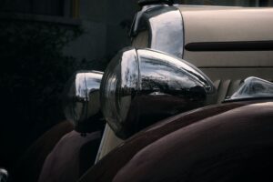 Vintage car headlights evoke the 1930s era in this image, fitting the theme of Bonnie and Clyde photos.