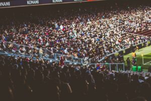 Texas vs Tennessee college football game with a packed stadium and cheering fans in the stands.