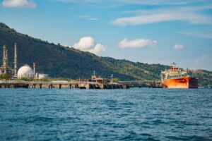 Oil tanker docked at an industrial port with refinery facilities, illustrating Donald Trump Corpus Christi visit and energy production.