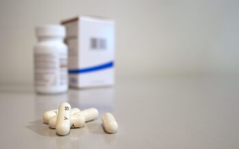 Prescription pills and medication bottle representing Texas fentanyl awareness and efforts to educate the public about opioid risks.